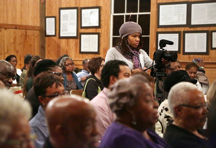 Ski Dauphiney runs the first camera during a civil rights symposium at the Penn Center National Historic Landmark District on St. Helena Island. Dauphiney worked on the crew and in post-production for the project.