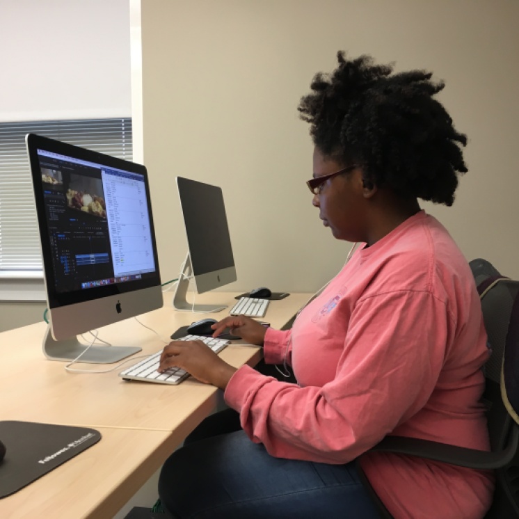 Valencia Abraham logs footage from the "Gullah Grub" restaurant during her Thursday shift.